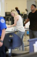 DAKOTA FANNING in Jeans at LAX Airport