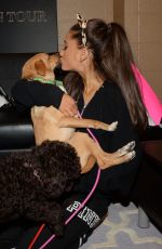 ARIANA GRANDE Plays with Dogs in New York