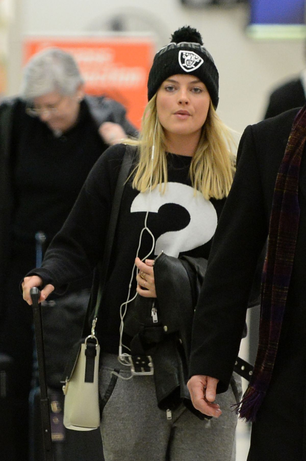 Margot Robbie arrives in style at JFK Airport but is feeling the cold