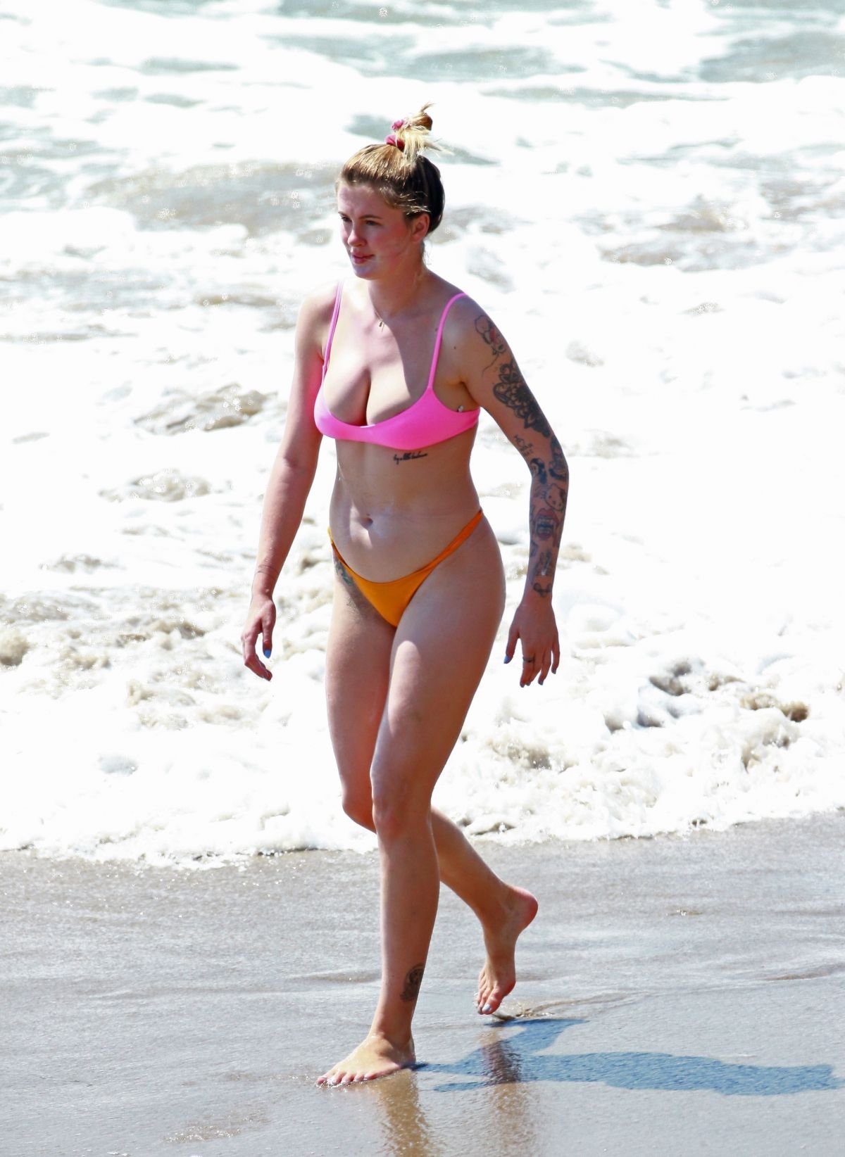 Ireland Baldwin has wardrobe malfunction as she falls out of bikini top  while surfing in Malibu