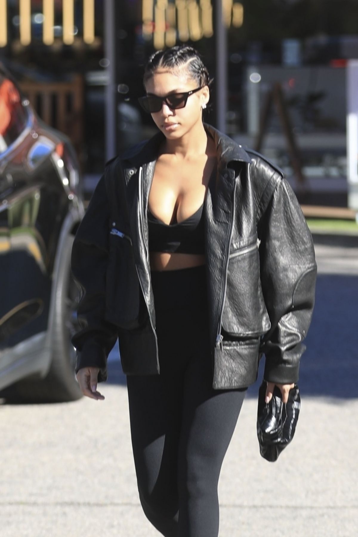 Lori Harvey sports black sports bra and leggings with a leather jacket  while stopping for a post-workout smoothie in Los Angeles