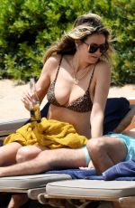HEIDI KLUM in Bikini at a Beach in Sardinia 06/19/2024